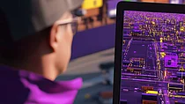 Eine Person betrachtet einen Bildschirm, der digitale Daten oder ein Dashboard mit lila Grafiken anzeigt. Das Bild repräsentiert die Umsetzung der Digitalisierung im SCM, passend zum SupplyX Barometer.